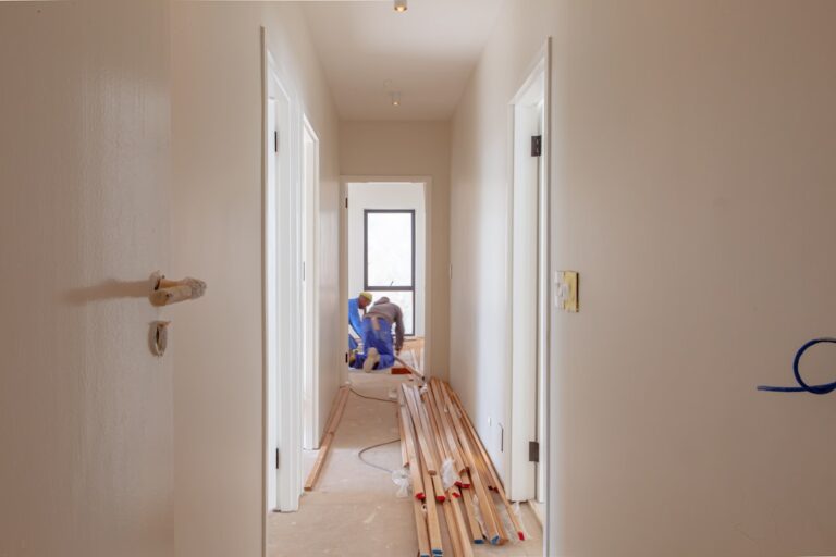 Flooring contractor installing hardwood plank flooring in a California home