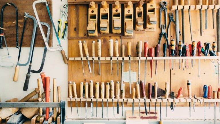 Hand tools organized on a workshop wall rack.
