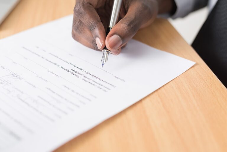 Contractor reviewing surety bond wording and obligee information on business paperwork